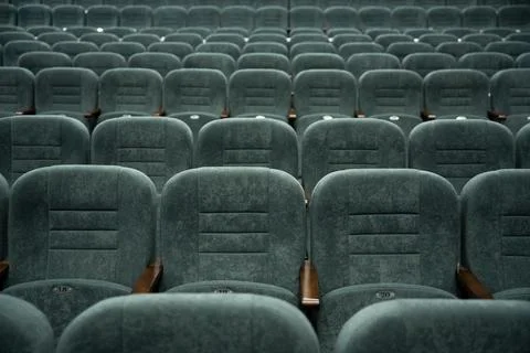 Empty rows of seats in the hall for a large number of people. Cinema and theatre Stock Photos