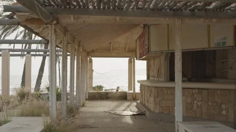 Empty ruined beach bar in old hotel resort by the sea during sunset or sunrise Stock Footage 337034023
