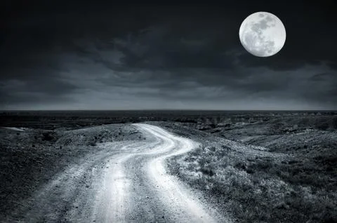 Empty rural road going through prairie at full moon night with dramatic cloud Stock Photos