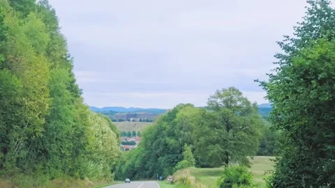 Empty Rural Road Leading Through Green Forest Landscape Stock Footage 345719634