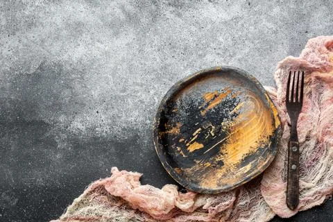 Empty rustic plate and cutlery on grey background. Top view Stock Photos