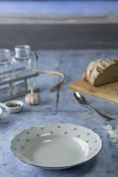 Empty rustic plate on blue wooden table Stock Photos