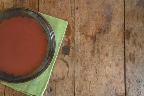 Empty rustic plate on the green napkin on the old wooden background Stock Photos