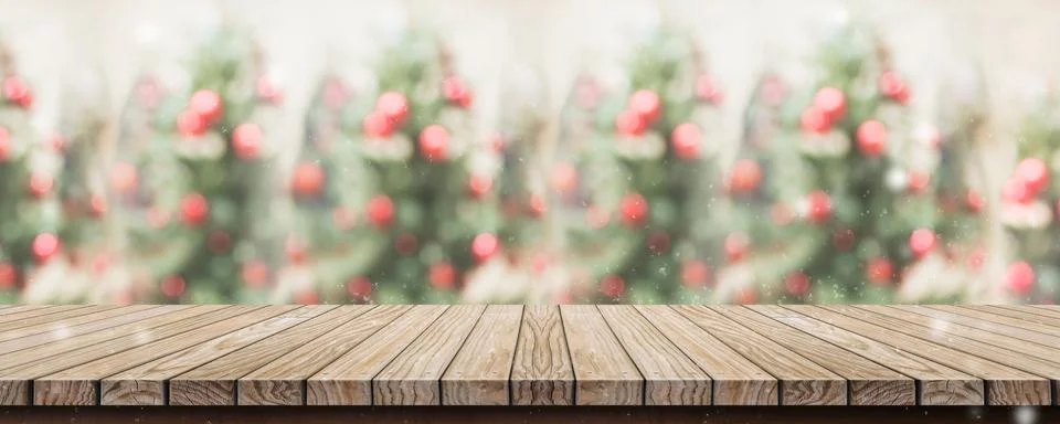 Empty rustic wood plank table top with abstract blur christmas tree red decor Stock Photos