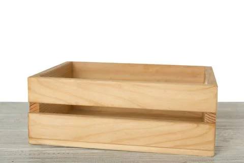 Empty rustic wooden crate on table against white background Stock Photos