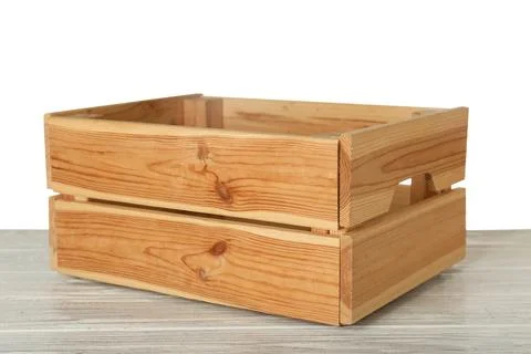 Empty rustic wooden crate on table against white background Stock Photos