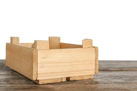 Empty rustic wooden crate on table against white background Stock Photos