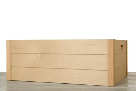 Empty rustic wooden crate on table against white background Stock Photos