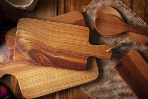 Empty rustic wooden cutting board for kitchen on old rustic wooden table. Tab Stock Photos