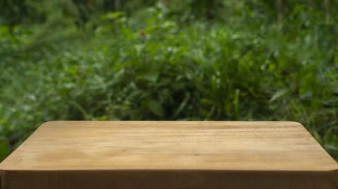 Empty Rustic Wooden Table with Green Blurred Nature Background Stock Photos