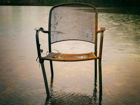 Empty Rusty Chair in Water Stock Photos