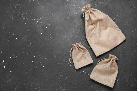 Empty sacks on grunge black background Stock Photos