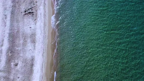 Empty sand beach and sea waves in the morning. Aerial view Stock Footage 139499809