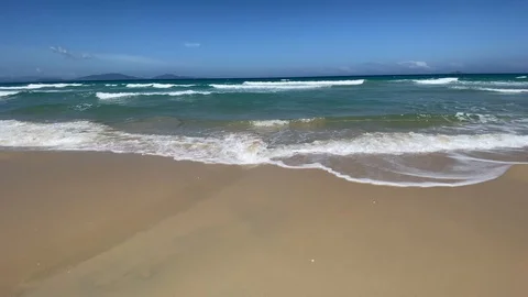 Empty sand beach with blue sea and blue sky background. waves at sea Stock Footage 127333205