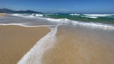 Empty sand beach with blue sea and blue sky background. waves Stock Footage 127333282