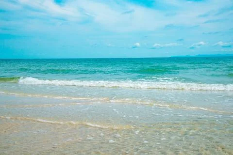 Empty sand beach with wave summer the ocean blue water background Stock Photos