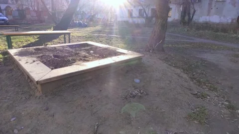Empty sandbox with trash bags and swing bench Stock Footage 219972849