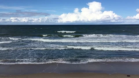 Empty sandy beach and beautiful sea with foamy waves Stock Footage 256216824