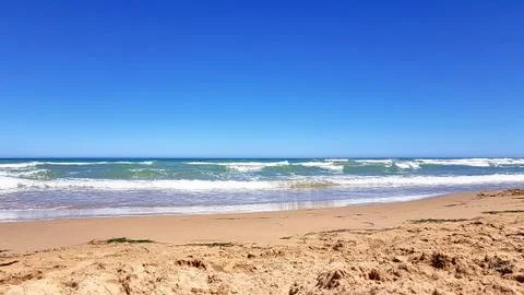 Empty sandy beach on the beach, summer. Stock Photos