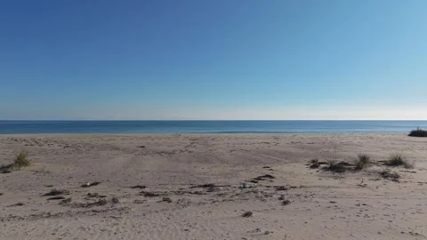 Empty Sandy Beach with Calm Sea and Clear Blue Sky Stock Footage 324528853