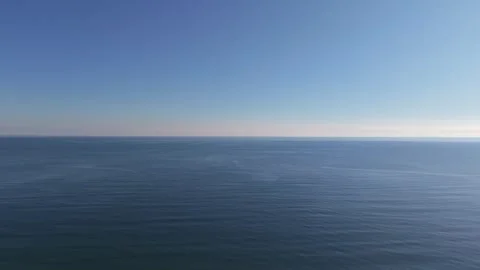 Empty Sandy Beach with Calm Sea and Clear Blue Sky Stock Footage 324528857