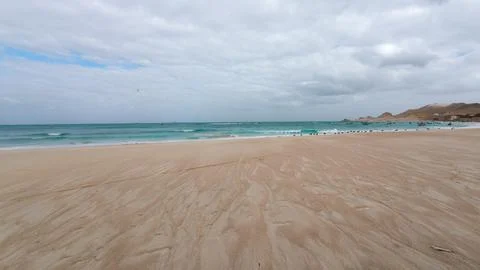Empty sandy beach under cloudy sky Stock Photos