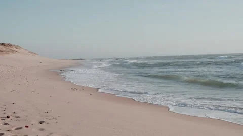 Empty sandy beach with waves and sand dunes on Portugal Atlantic coast Stock Footage 337496044