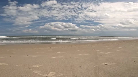 Empty Sandy Ocean Beach with Waves and Dramatic Cloudy Sky. Stock Footage 330564305