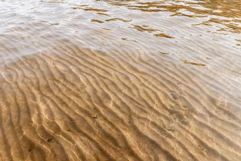 Empty sandy seabed is under shallow water Stock Photos