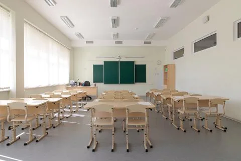 Empty school class before final exams. Sheets for tests are laid out on the d Stock Photos