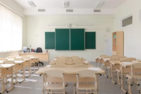Empty school class before final exams. Sheets for tests are laid out on the d Stock Photos