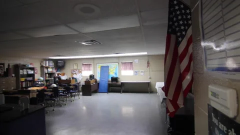 Empty School Classroom With American Flag Track From Door Video stock 134194234