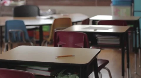Empty school classroom dolly across desks Stock Footage