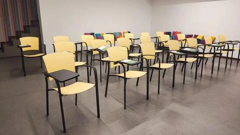 Empty school classroom with test sheet or exam paper on desks, chair. Stock Photos