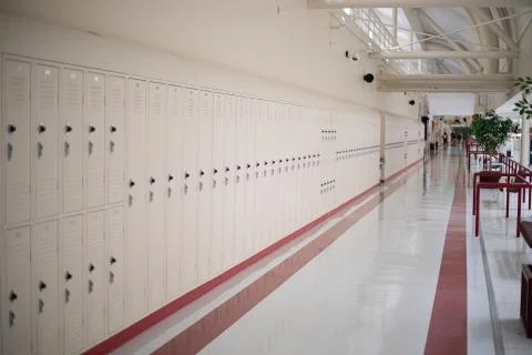 Empty school hallway lined with lockers Stock Photos