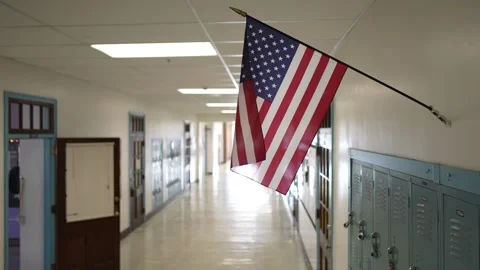Empty School Hallway With Lockers and American Flag Hanging Above Stock Footage 294188330