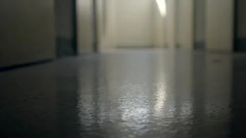 Empty school hallway low angle with reflective worn floor Video stock 347221419