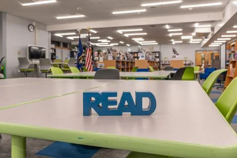 Empty school library with blue block read sign on work table. Stock Photos