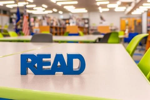 Empty school library with blue block read sign on work table. Stock Photos