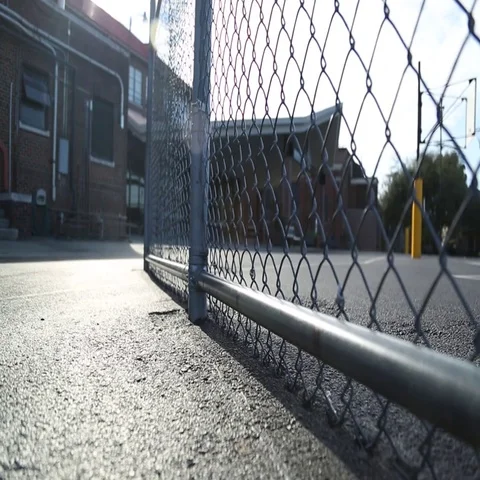 Empty schoolyard, chain link fence, basketball goal Video stock 69547320