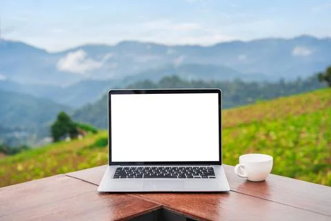 Empty screen laptop with cup of coffee with mountain view Fotos Stock