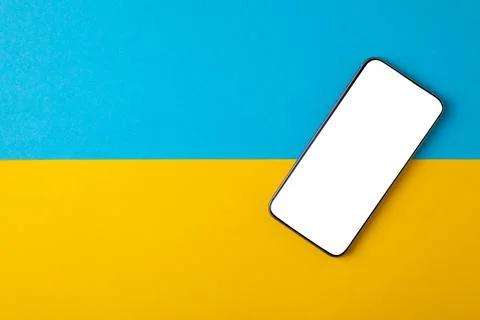 Empty screen mobile phone on the background of the flag of ukraine 스톡 사진