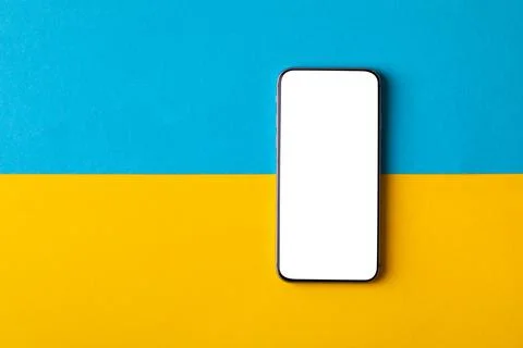 Empty screen mobile phone on the background of the flag of ukraine 스톡 사진