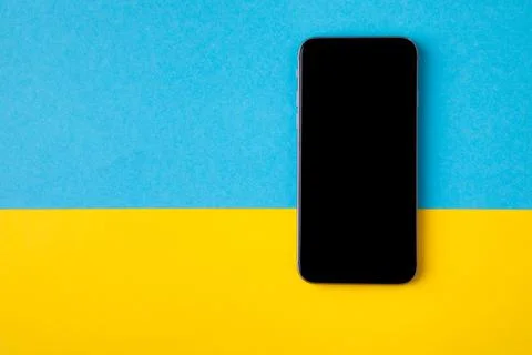 Empty screen mobile phone on the background of the flag of ukraine Stock Photos