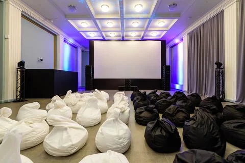 Empty screening room with beanbags, set for startup pitch night and indie Stock Photos