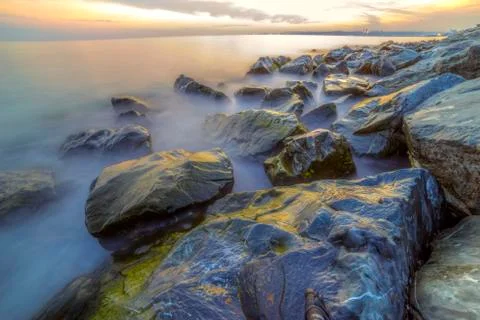 Empty sea and rocks During the sunset with Silky Sea Foto stock
