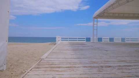 Empty sea beach with a summer cafe, white empty wooden terrace, waiting for Stock Footage 128817717