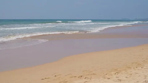 Empty sea ocean coast sand beach with long waves and turquoise water in tropics. Stock Footage 240368901