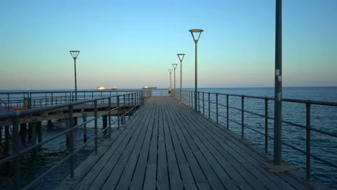 Empty sea pier on the background of a beautiful sunset. Steady cam shot. Stock Footage 203931368