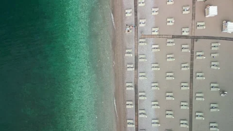 Empty sea sandy beach with sun beds and umbrellas Stock Footage 246391178
